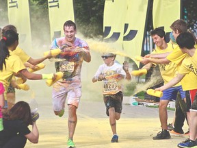 Justin Oddy, left, and Jack Dollar get coloured yellow as they near the finish line during The Color Run on Windsor's riverfront on Saturday, July 20, 2013. (REBECCA WRIGHT/ The Windsor Star)