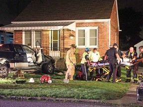 Emergency personnel work to free a man from a pickup truck he crashed into the front porch of a home on the 1600 block of Hickory Road, early Sunday morning, July 7, 2013.   (REBECCA WRIGHT/The Windsor Star)