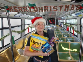 Transit Windsor held a Christmas In July Food Drive Thursday, July 25, 2013, at the Devonshire Mall in Windsor, Ont. The aim of the event was to collect items for the Downtown Mission food bank and other local organizations. Mary-Jo Kovacs, food room supervisor with the Downtown Mission poses inside the bus.(DAN JANISSE/The Windsor Star)