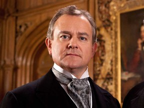 This publicity image released by PBS shows Hugh Bonneville in a scene from the popular series "Downtown Abbey." Bonneville was nominated for an Emmy Award for best actor in a drama series on, Thursday July 18, 2013. The Academy of Television Arts & Sciences' Emmy ceremony will be hosted by Neil Patrick Harris. It will air Sept. 22 on CBS. (AP Photo/PBS, Josh Barratt)