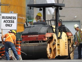 Employees with Coco Paving work on a hot morning, in this file photo from Monday, July 15, 2013, in downtown Windsor.