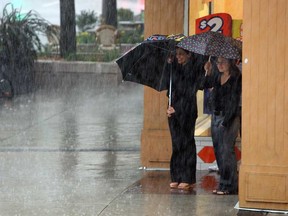 Showers send people scrambling in downtown Windsor on Thursday, July 18, 2013. A brief storm rolled through in the early afternoon dropping massive amounts of rain and lightning.             (TYLER BROWNBRIDGE/The Windsor Star)