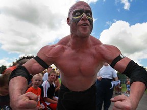 Road Warrior Rage flexes after competing in a bout as wrestlers from Classic Championship Wrestling perform at the 2013 Essex Fun Fest on the grounds of the Essex Arena, Saturday, July 13, 2013.  The wrestling action drew a large crowd. (DAX MELMER/The Windsor Star)