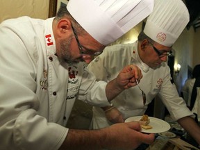 Chefs Helmut Markert, left, and John Carlo Felicella prepare food at a culinary gala at Essex Golf and Country Club in LaSalle, Ont., Friday, June 28, 2013.  The Culinary Team Canada served up a multi-course meal to hone their skills in preparation for the Culinary Olympics in Germany.  (DAX MELMER/The Windsor Star)
