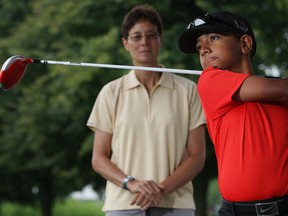 Shawn Sehra, right, practises his swing with his coach Joye McAvoy-Sinn at Silver Tee Golf Centre. (DAX MELMER/The Windsor Star)