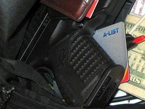 This handout photo provided by the Transportation Security Administration (TSA), taken in April 2013 at Indianapolis International Airport, shows a gun among personal belongings that was confiscated in a carry-on bag at the airport.  (AP Photo/TSA)