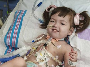 In this April 26, 2013 file photo provided by OSF Saint Francis Medical Center in Peoria, Ill., Hannah Warren, 2, lies in bed in a post-op room at the Children's Hospital of Illinois in Peoria, after having received a new windpipe in a landmark transplant operation on April 9, 2013. Hannah, who was born in South Korea without a windpipe received a new one made from her own stem cells, died Saturday, July 6, 2013. She was the youngest patient in the world to benefit from the experimental treatment. (AP Photo/OSF Saint Francis Medical Center, Jim Carlson, File)