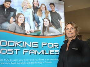 Erin Wladarski, relationship manager for the Canada Homestay Network, is shown in front of one of the organization's posters in her home in LaSalle, Ont. on Sunday, July 7, 2013. Homestay is in need of host families for this coming school year. (REBECCA WRIGHT/ The Windsor Star)