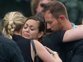 Maximus Huyskens' mother (second left) and father (right) are consoled by family and friends following the 2-year-old boys funeral at Holy Rosary Catholic Church in Milton, Ontario, July 3, 2013. The boy died last week after being left in a hot car by his grandmother. (Tyler Anderson/National Post)