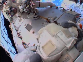 This July 16, 2013 NASA TV image shows International Space Station(ISS) Italian astronaut Luca Parmitano (Bottom) as he discusses a leak with Mission Control as Chris Cassidy(Top) looks on, just prior to aborting their space walk. Parmitano had a leak in his helmet while doing a spacewalk at the International Space Station Tuesday, forcing an early end to the outing, NASA said. "A little more (than) one hour into the spacewalk, Luca Parmitano of the European Space Agency reported water free-floating behind his head inside his helmet," the US space agency said. Parmitano and fellow US astronaut Chris Cassidy made it back into the orbiting research lab at about 1329 GMT, according to NASA television. AFP PHOTO / NASA TV /