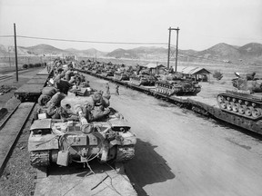 In this May 13, 1952 file photo, tanks of the First Marine Division are loaded on flatcars at Munsan, Korea, before moving to the front in April. Thomas Hudner, now a retired Navy captain, heads to Pyongyang on Saturday, July 20, 2013 with hopes of travelling in the coming week to the region known in North Korea as the Jangjin Reservoir, accompanied by soldiers from the Korean People's Army, to the spot where the Navy's first black pilot, Ensign Jesse Brown died in December 1950. The reservoir was the site of one of the Korean War's deadliest battles for Americans, who knew the place by its Japanese name, Chosin. The snowy mountain region was nicknamed the "Frozen Chosin," and survivors are known in U.S. history books as the "Chosin Few." (AP Photo, File)