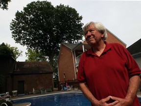 Homeowner John McKay, right, has agreed to take down a large oak tree in Lincoln of Woods, following a lengthy lawsuit filed by his neighbour, but area residents including Greig Zimmerman, left, have a petition to save the old oak, Wednesday July 3, 2013. (NICK BRANCACCIO/The Windsor Star)