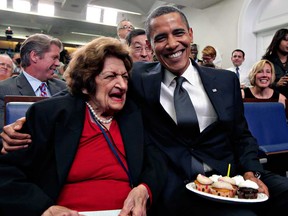 In this Aug. 4, 2009, file photo, veteran White House reporter Helen Thomas, left, celebrates her 89th birthday with President Barack Obama, celebrating his 48th birthday, in the White House Press Briefing Room in Washington. Thomas, a pioneer for women in journalism and an irrepressible White House correspondent, died Saturday, July 20, 2013. She was 92. (AP Photo/J. Scott Applewhite, File)