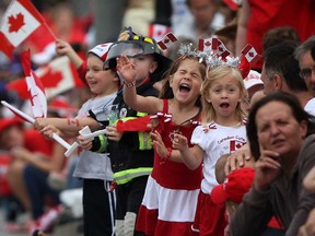 Kids cheer on the parade participants at the 2013 Canada Day Parade in Windsor, Ont., Monday, July 1, 2013.  (DAX MELMER/The Windsor Star)