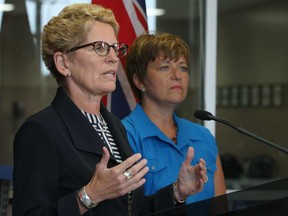 In this file photo, Premier Kathleen Wynne, left, is joined by Windsor West MPP Teresa Piruzza at a press conference at Leggett and Pratt Automotive Group in Lakeshore, Ont., Monday, July 22, 2013.  (DAX MELMER/The Windsor Star)