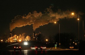 In this file photo, cars travel along E.C. Row west near Matchette Rd. as the Zug Island towers glow in the background. (Dan Janisse/The Windsor Star)