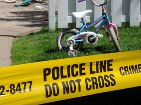 Police tape at the scene where a 3 yr. old child died after being left unattended in a vehicle in northeast Edmonton as temperatures soared above 30 C. Police responded shortly after 6:30 p.m. to the Parkridge Estates townhouse complex at 2908 116A Ave. in Edmonton, July 3, 2013. (Bruce Edwards/Edmonton Journal)