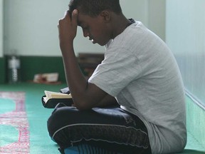 Yasir Sheiknur, 14, reads the Quran at the Windsor Mosque, Tuesday, July 9, 2013, in Windsor, Ont. Local Muslims are preparing to celebrate Ramadan. (DAN JANISSE/The Windsor Star)