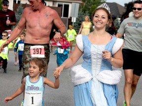 Annie Winkler, right, dressed as Cinderella, holds hands with a young runner as they participate in one of the runs during the eighth annual Running From Cancer held at Tecumseh Arena on Sunday, July 28, 2013. (REBECCA WRIGHT/ The Windsor Star)