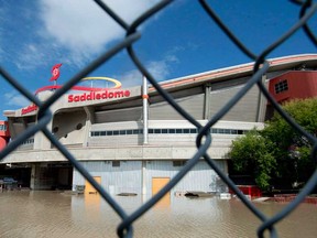 The Saddledome is surrounded by water in downtown Calgary, Alta., Sunday, June 23, 2013. Calgary Stampede organizers say some signature events this year have been cancelled because flood repairs to the Saddledome cannot be completed in time. Stampede spokesman Kurt Kadatz says the Calgary Flames have informed Stampede officials that the building won't be ready for the first five days of this year's festival. (THE CANADIAN PRESS/Jonathan Hayward)