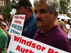 A protester at a July 3, 2013 open house held by the Windsor Port Authority on development of Ojibway Shores. (Doug Schmidt / The Windsor Star)