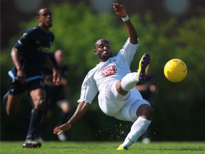 Windsor's Stephen Ademolu, right, kicks the ball while falling against Toronto Croatia Sunday at Windsor Stadium.  (DAX MELMER/The Windsor Star)