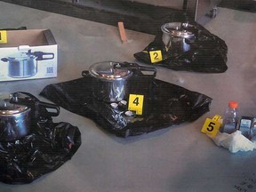 An RCMP photograph of pressure cookers they say two people intended to use as explosive devices is displayed during a news conference to announce terrorism charges in Surrey, B.C., on Tuesday, July 2, 2013. The charges are in connection to an alleged Al-Qaeda-inspired plot to explode a bomb at the B.C. Legislature on Canada Day. (THE CANADIAN PRESS/Darryl Dyck)