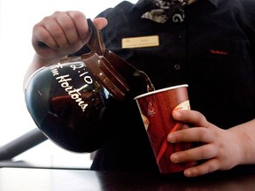 A cup of coffee is poured at a Tim Hortons coffee shop in this file photo. (THE CANADIAN PRESS/Chris Young)