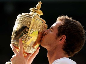 Andy Murray of Great Britain kisses the Gentlemen's Singles Trophy following his victory in the Gentlemen's Singles Final match against Novak Djokovic of Serbia on Day 13 of the Wimbledon Lawn Tennis Championships at the All England Lawn Tennis and Croquet Club on July 7, 2013, in London.  (Clive Brunskill/Getty Images)