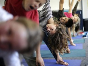 In this Dec. 11, 2012 file photo, students hold their position during a yoga class at Capri Elementary School in Encinitas, Calif. A San Diego County judge has ruled that the Encinitas Union School District was not teaching religion by offering yoga classes. (AP Photo/Gregory Bull, File)