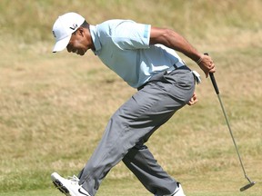 Tiger Woods of the United States reacts after putting on the 9th green during the second round of the British Open Golf Championship at Muirfield, Scotland, (AP Photo/Scott Heppell)