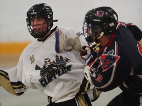 Windsor's Ryan Marchand, left, is checked by Mackenzie Wilkinson of London in playoff action from Forest Glade Arena. (NICK BRANCACCIO/The Windsor Star)