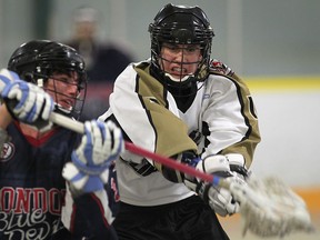 Windsor's Tyler McDowall, right, battles Mackenzie Wilkinson of London during the first round of the playoffs at Forest Glade Arena. (DAN JANISSE/The Windsor Star)