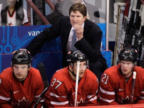 Canada head coach Mike Babcock watches as his team plays Germany in the second period of a men's playoff qualifying round game at the Vancouver 2010 Olympics in Vancouver. (THE CANADIAN PRESS/AP, Mark Humphrey)