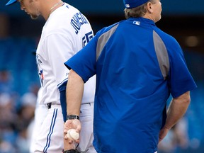 Toronto Blue Jays starting pitcher Josh Johnson, left, is pulled by manager John Gibbons during the third inning against the Los Angeles Dodgers Monday. (THE CANADIAN PRESS/Frank Gunn)