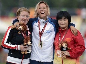 Windsor's Virginia McLachlan, from left, Italian gold medallist Oxana Corso and  Chinese bronze medallist Ping Liu pose on the podium of the Women's 100m T35 at the IPC Athletics World Championships in France. (AFP photo/Getty Images)