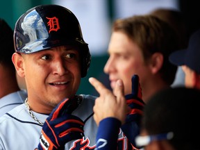 Miguel Cabrera of the Detroit Tigers is congratulated by teammates after hitting a home run against the Kansas City Royals at Kauffman Stadium Monday. (Photo by Jamie Squire/Getty Images)