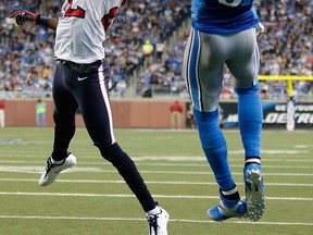 Houston's Alan Ball, left, tries to defend a touchdown catch by Calvin Johnson of the Detroit Lions at Ford Field. (Photo by Gregory Shamus/Getty Images)