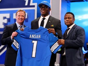 Ezekiel (Ziggy) Ansah of the BYU Cougars stands with NFL commissioner Roger Goodell, left, and Pro Football Hall of Famer Barry Sanders after Ansah was picked fifth overall by the Detroit Lions in the first round of the 2013 NFL Draft at Radio City Music Hall in New York. (Photo by Al Bello/Getty Images) ORG XMIT: 163512005