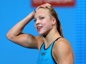 Ruta Meilutyte of Lithuania celebrates after finishing first in the women's 100m breaststroke final at the FINA World Championships. Meilutyte competed in the International Children's Games. (Photo by Alexander Hassenstein/Getty Images)