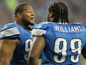 Lions defensive tackle Ndamukong Suh, left, talks with teammate Corey Williams during the game against the Green Bay Packers at Ford Field. (Photo by Leon Halip/Getty Images)