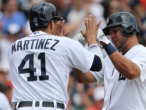 Detroit's Victor Martinez, left, and Jhonny Peralta celebrate after scoring on the double by Ramon Santiago during the second inning against the Washington Nationals at Comerica Park Wednesday.  (Photo by Leon Halip/Getty Images)