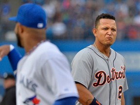 Tigers third baseman Miguel Cabrera, right, reacts next to Blue Jays second baseman Emilio Bonifacio during the first inning in Toronto Tuesday.(THE CANADIAN PRESS/Nathan Denette)