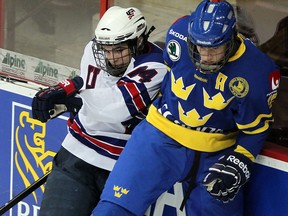 Sweden's Jacob De La Rosa, right, is checked by Will Butcher of the United States at the 2012 World Under-17 Hockey Challenge at the WFCU Centre. (NICK BRANCACCIO/The Windsor Star)