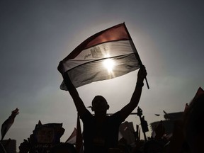 An Egyptian protester waves his national flag as thousands celebrate on July 1, 2013 in Cairo's landmark Tahrir square after Egypt's armed forces gave President Mohamed Morsi 48 hours to meet the demands of the people or it would intervene with a roadmap. AFP PHOTO/GIANLUIGI GUERCIA