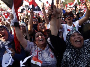 Egyptian women shout slogans against President Mohammed Morsi as they join hundreds of thousands demonstrating against President Mohammed Morsi and the Muslim brotherhood outside the Egyptian presidential palace on July 3, 2013 in Cairo, Egypt. Cheers erupted, firecrackers ignite and horns were honked as soon as the army announced President Mohamed Morsi's rule was over, ending Egypt's worst crisis since its 2011 revolt. AFP PHOTO/MAHMOUD KHALED