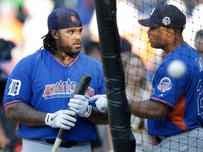 the American League’s Robinson Cano, right, of the New York Yankees, speaks with teammate Prince Fielder, of the Detroit Tigers, during batting practice before the MLB All-Star baseball game, on Tuesday, July 16, 2013, in New York. (AP Photo/Kathy Willens)