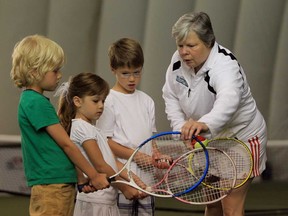 Nancy Loeffler-Caro, right, instructs junior tennis players from left, Bence Wesseling, Stasia Kryk and Tristan Kryk during the AMA Tennis Club's Breakfast at Wimbledon event at the Dominion Golf Dome July 6, 2013 in LaSalle (JASON KRYK/The Windsor Star)