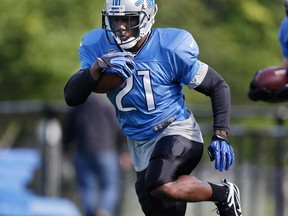 Detroit Lions running back Reggie Bush runs through drills during an NFL football training camp in Allen Park, Mich., Sunday, July 28, 2013. (AP Photo/Carlos Osorio)