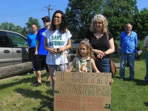 Madeline Perry, 7, holds a sign in support of Ojibway Shores at a press conference held by MP Brian Masse on July 12, 2013. (Jason Kryk / The Windsor Star)